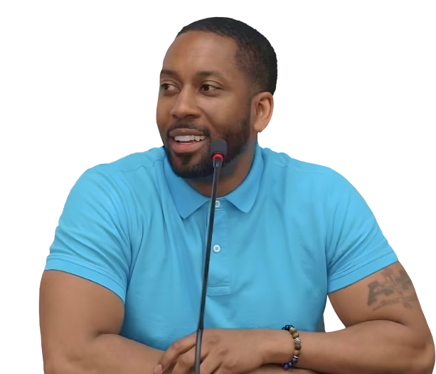 Jonathan Quarles seated with a microphone, wearing a blue T-shirt